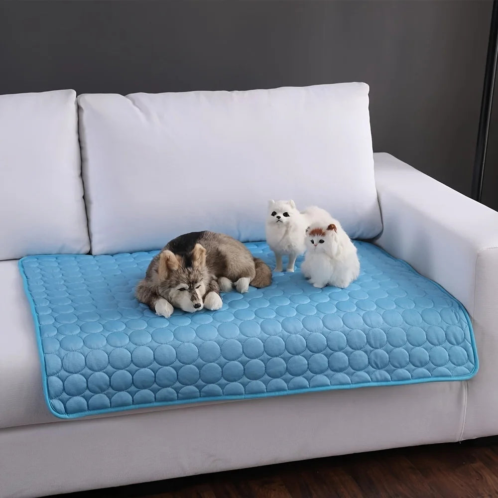 CoolPaws self-cooling mat for dogs - blue - three small dogs resting on mat placed on white sofa